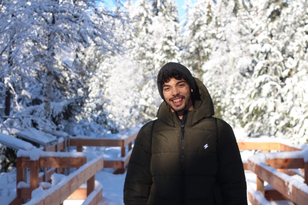 A picture of me standing infront of a snow forest background
